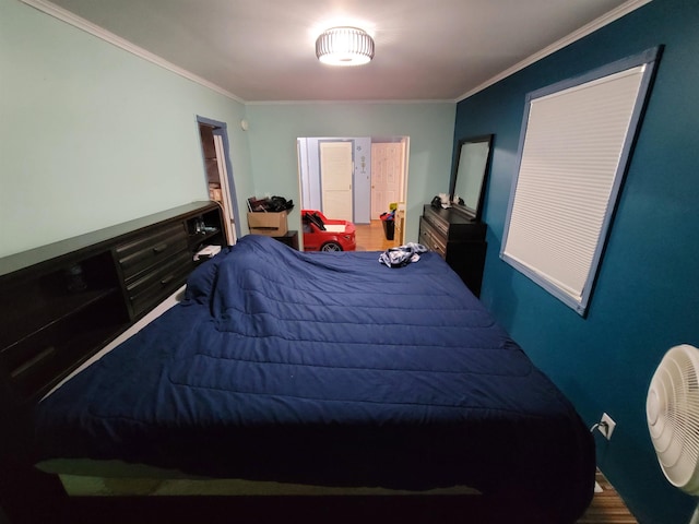 bedroom with ornamental molding and wood-type flooring