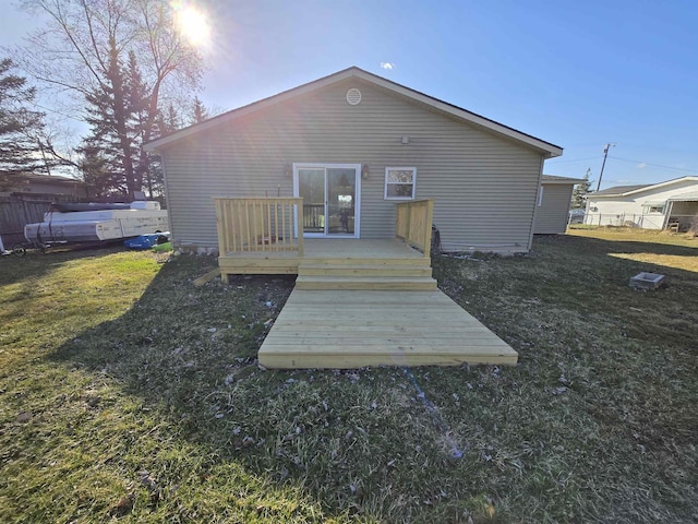 7412 N Webster Rd, Mount Morris, MI 48458 - rear view of property featuring a lawn, fence, and a wooden deck