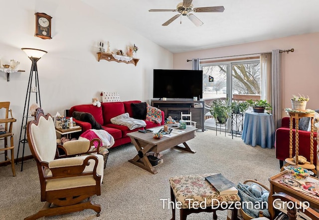 carpeted living room with lofted ceiling and ceiling fan