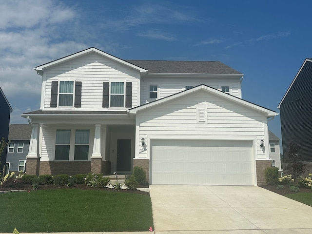 view of front of property with a garage, a front lawn, and covered porch