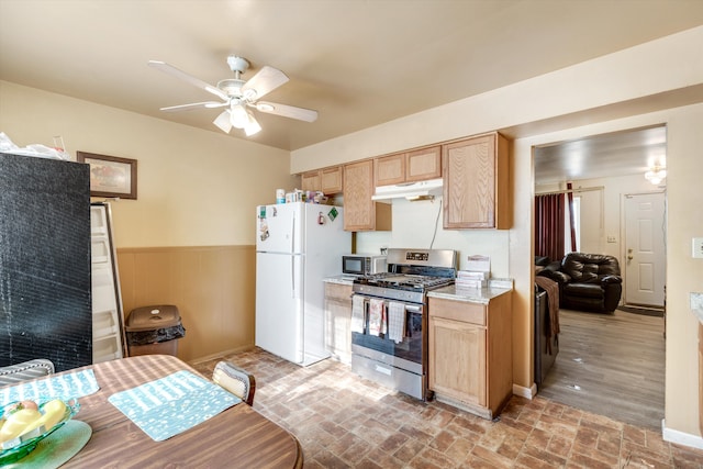 kitchen featuring stainless steel appliances, ceiling fan, and light brown cabinetry