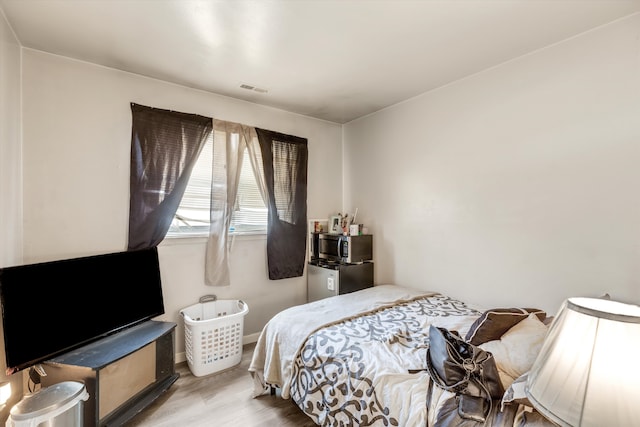 bedroom with light hardwood / wood-style floors