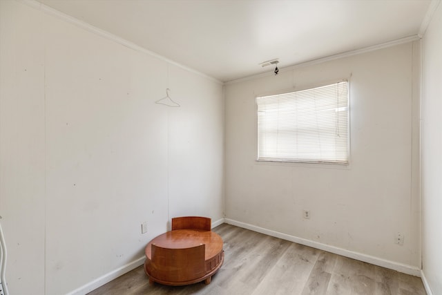 unfurnished room featuring crown molding and light hardwood / wood-style flooring