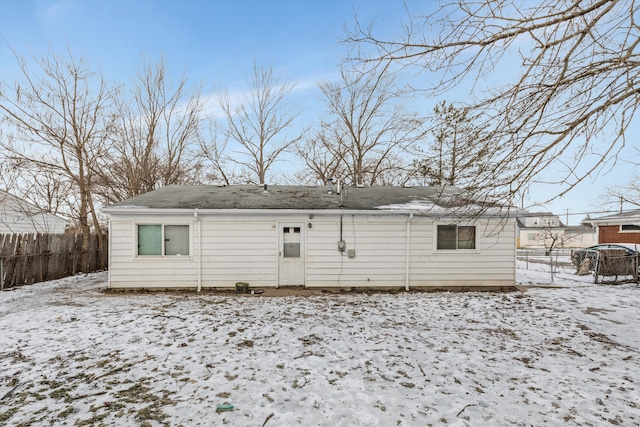 view of snow covered rear of property