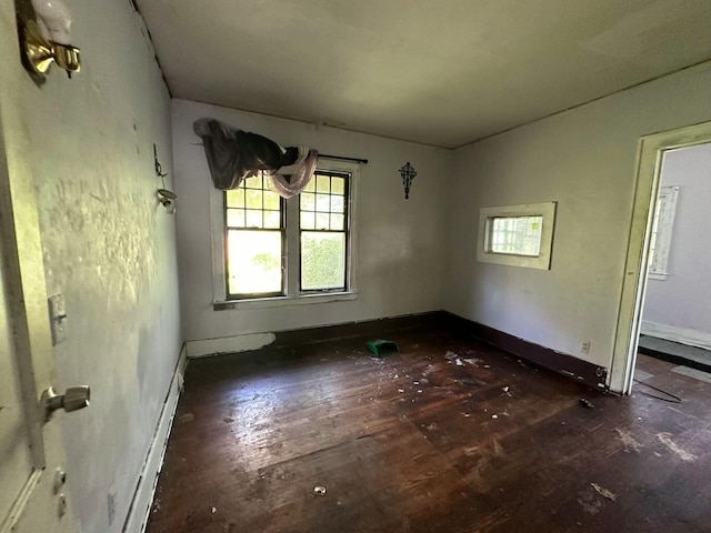 unfurnished room with dark hardwood / wood-style floors