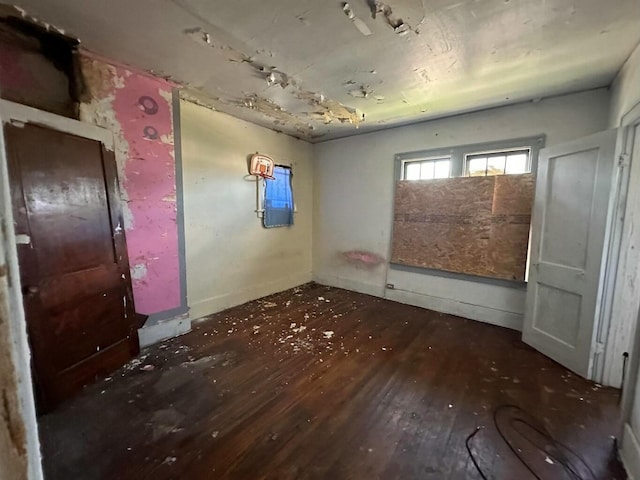 unfurnished room with dark wood-type flooring