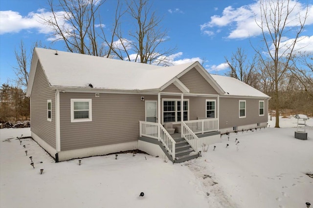 view of snow covered rear of property