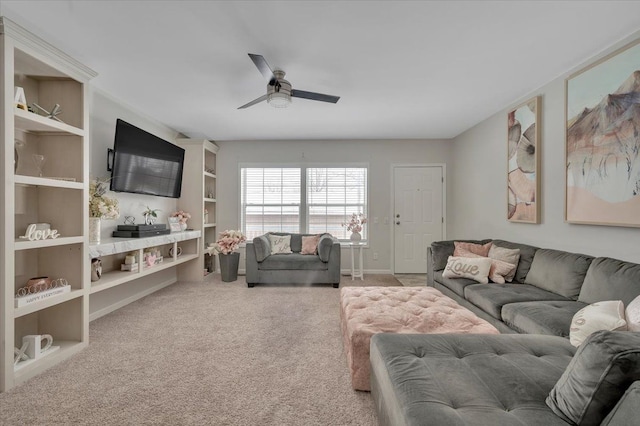 carpeted living room with ceiling fan