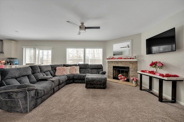 living room featuring carpet, a wealth of natural light, a fireplace, and ceiling fan