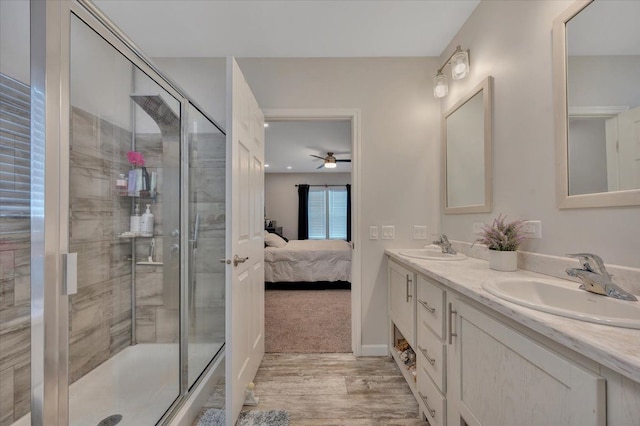 bathroom with wood-type flooring, an enclosed shower, and vanity