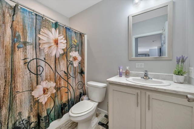 bathroom with walk in shower, vanity, and toilet