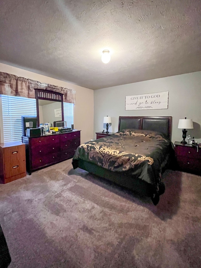 bedroom featuring a textured ceiling and carpet