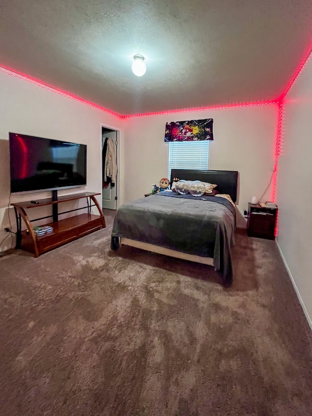 carpeted bedroom featuring a textured ceiling