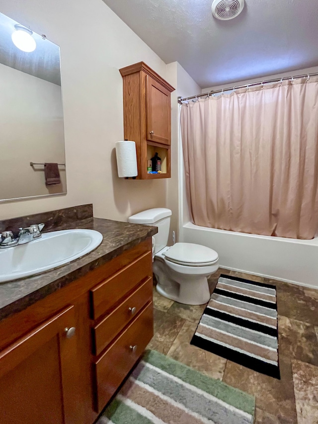 full bathroom featuring shower / bath combo, toilet, and vanity