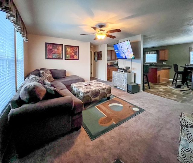 carpeted living room featuring ceiling fan