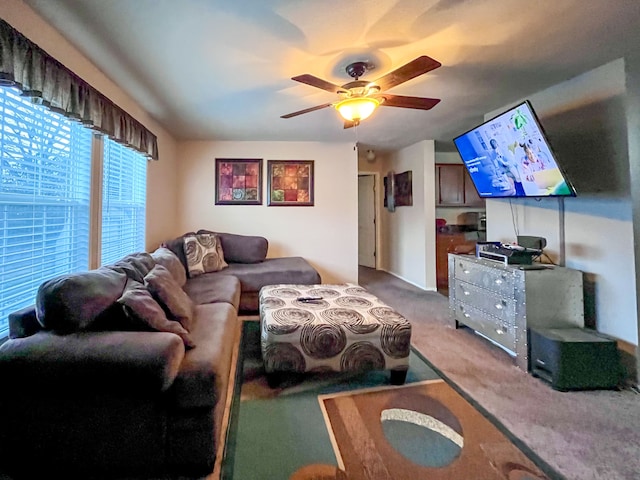 carpeted living room featuring ceiling fan