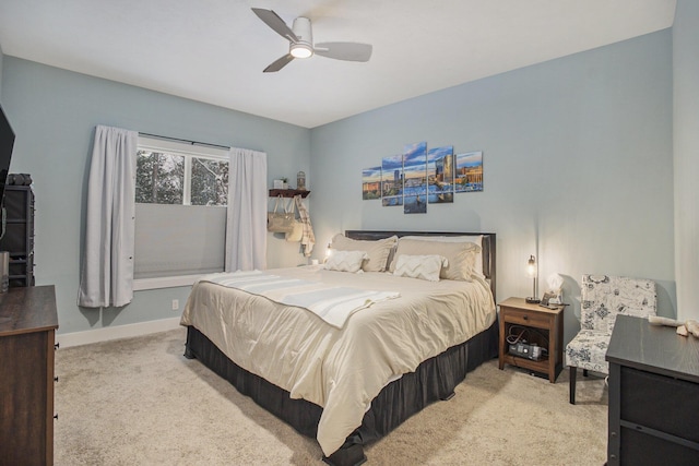 bedroom with ceiling fan and light colored carpet