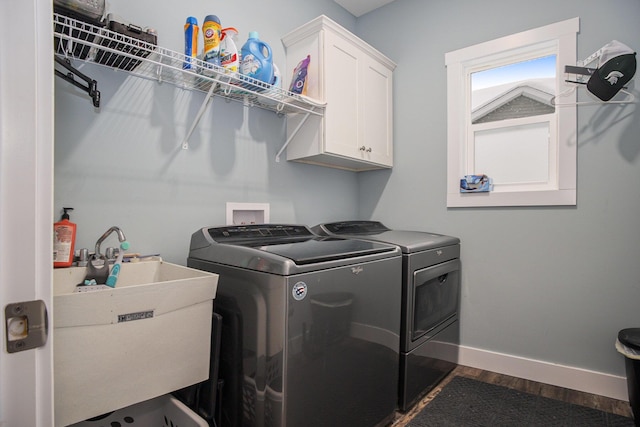 washroom with sink, separate washer and dryer, cabinets, and dark hardwood / wood-style flooring