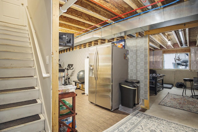 basement with stainless steel fridge