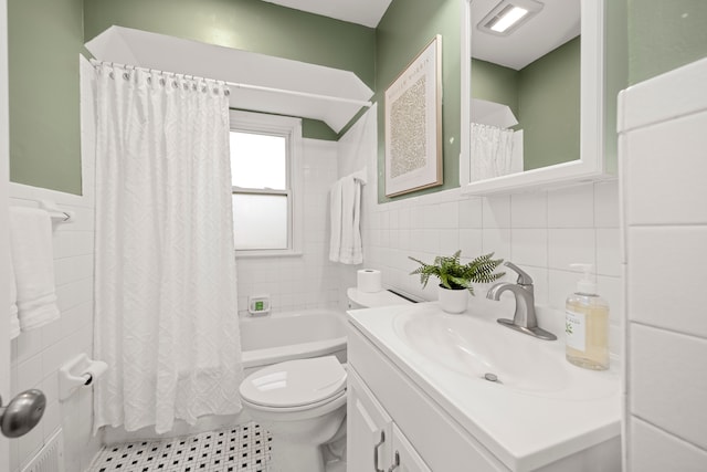 full bathroom with tile walls, vanity, toilet, and shower / bathtub combination with curtain