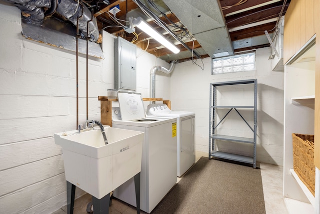 laundry room with separate washer and dryer, sink, and electric panel