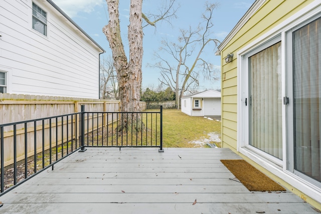 wooden terrace featuring a lawn