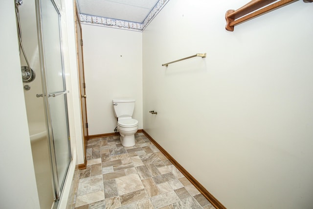 bathroom featuring toilet and an enclosed shower