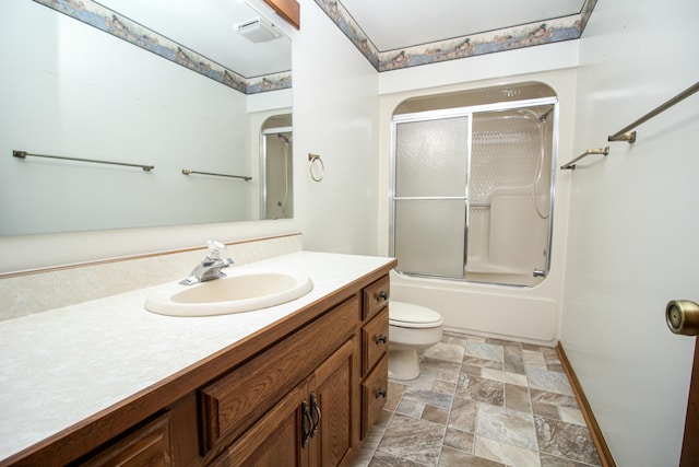 full bathroom with toilet, shower / bath combination with glass door, and vanity