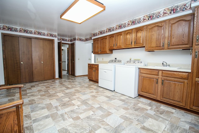 kitchen featuring sink and washing machine and clothes dryer