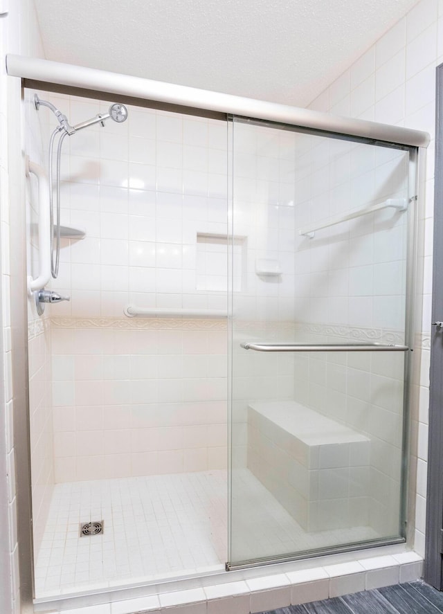 bathroom featuring a shower with door