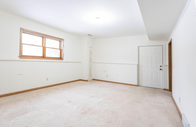 spare room featuring light colored carpet