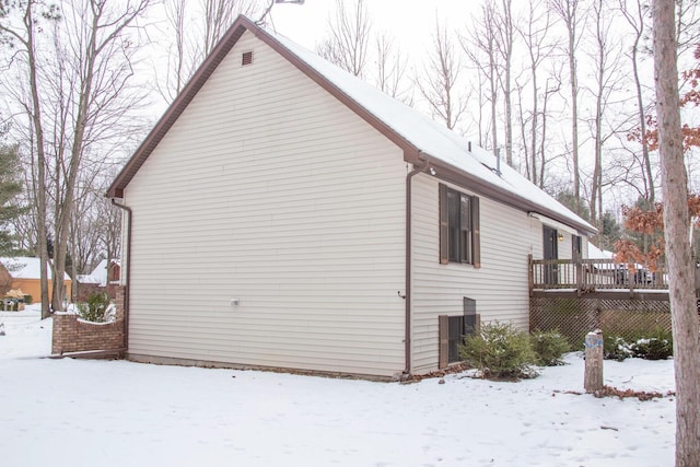 snow covered property with a wooden deck