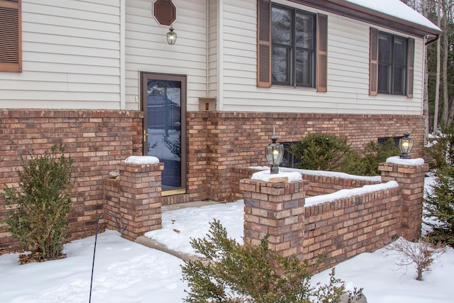 view of snow covered property entrance