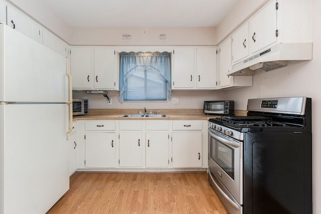 kitchen featuring white cabinetry, sink, light hardwood / wood-style flooring, and appliances with stainless steel finishes