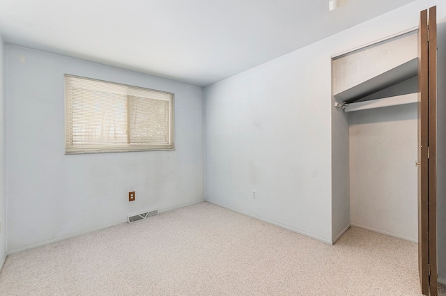 unfurnished bedroom featuring light colored carpet