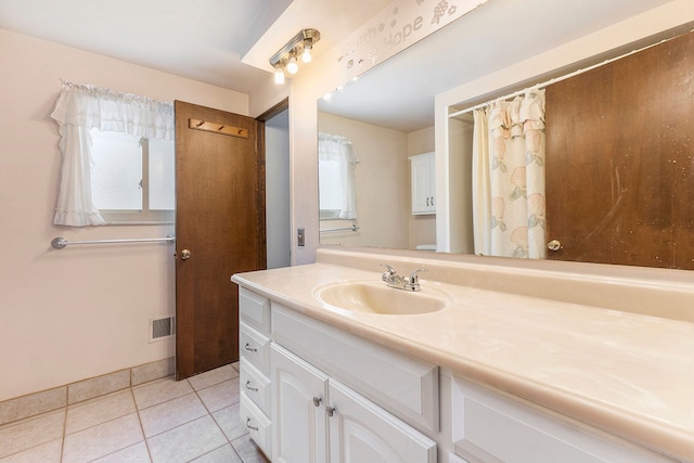 bathroom with tile patterned flooring and vanity