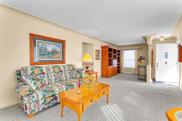 carpeted living room featuring baseboards