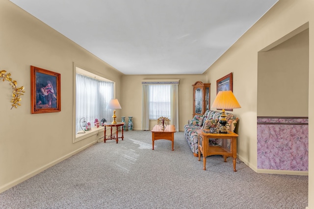 sitting room featuring carpet flooring and baseboards