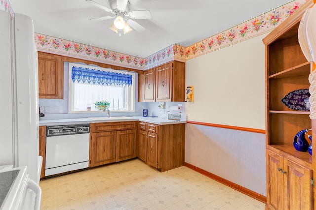 kitchen with range, white dishwasher, light countertops, light floors, and a sink