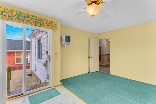 interior space with baseboards, a ceiling fan, and carpet flooring