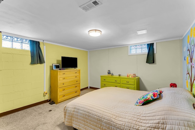 bedroom with carpet floors, baseboards, visible vents, and concrete block wall