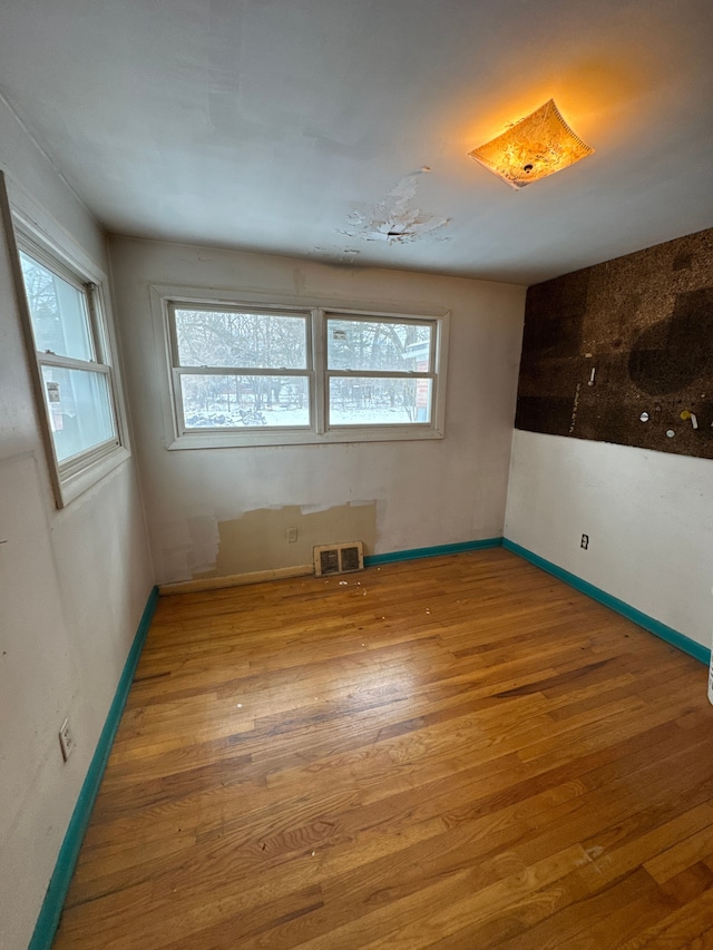 spare room with hardwood / wood-style floors