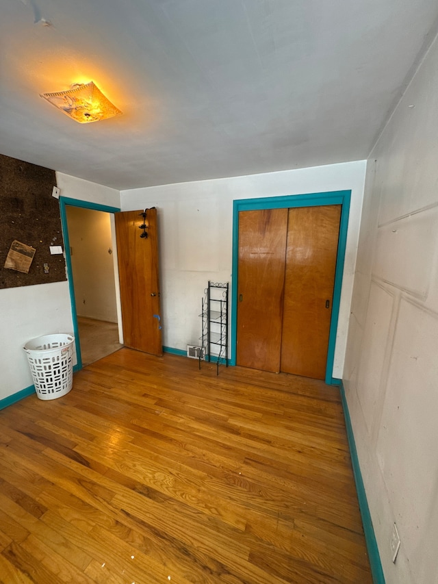 interior space with hardwood / wood-style floors and a closet