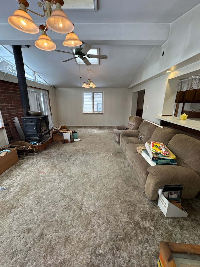 carpeted living room featuring lofted ceiling with beams, ceiling fan, and a wood stove