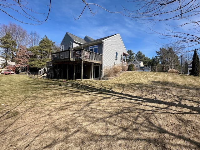 view of home's exterior featuring a deck, stairs, and a yard