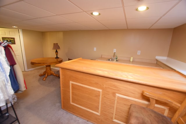 bar with a drop ceiling, butcher block countertops, sink, and carpet flooring