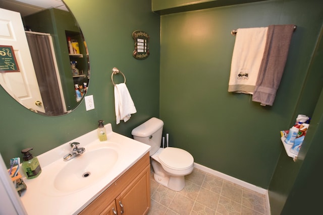 bathroom with vanity, toilet, and tile patterned flooring