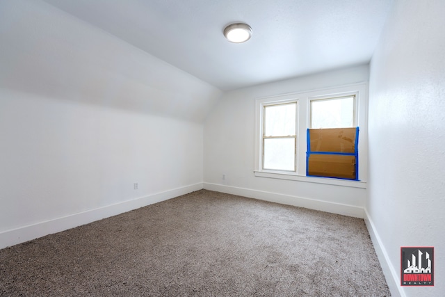 bonus room featuring carpet floors and vaulted ceiling