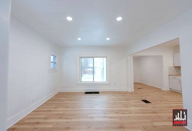 unfurnished room with light wood-type flooring