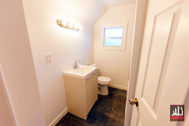 bathroom featuring vaulted ceiling, vanity, and toilet